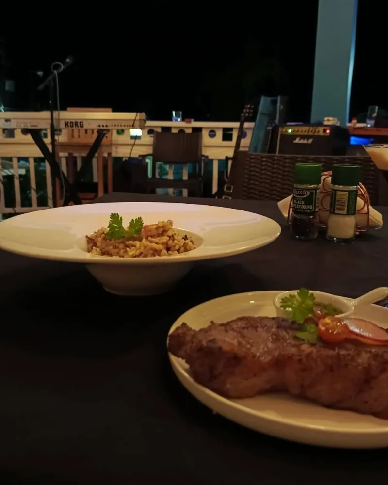 Steak dinner and cocktails on the veranda at night